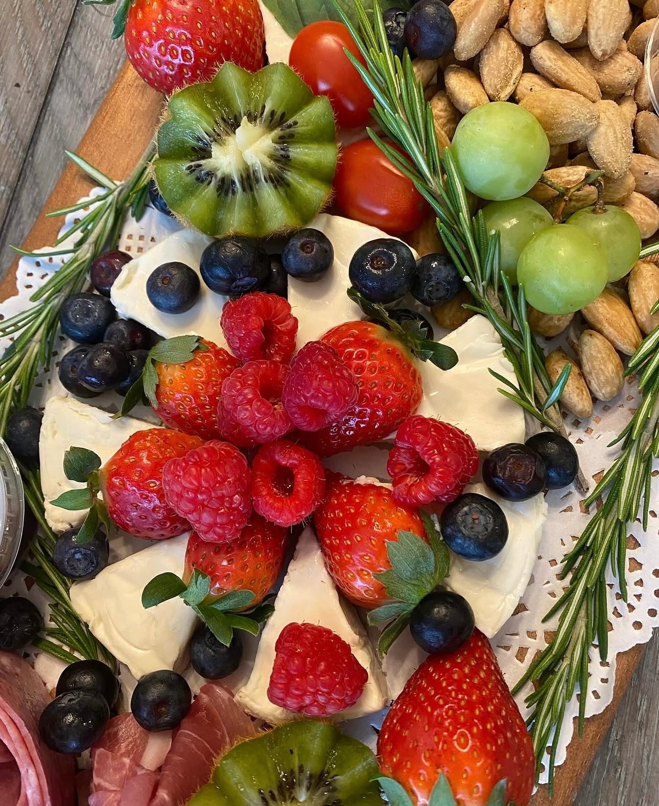 Hunt & Honey brie board with fresh strawberries, raspberries, blueberries, kiwi, grapes, almonds and rosemary